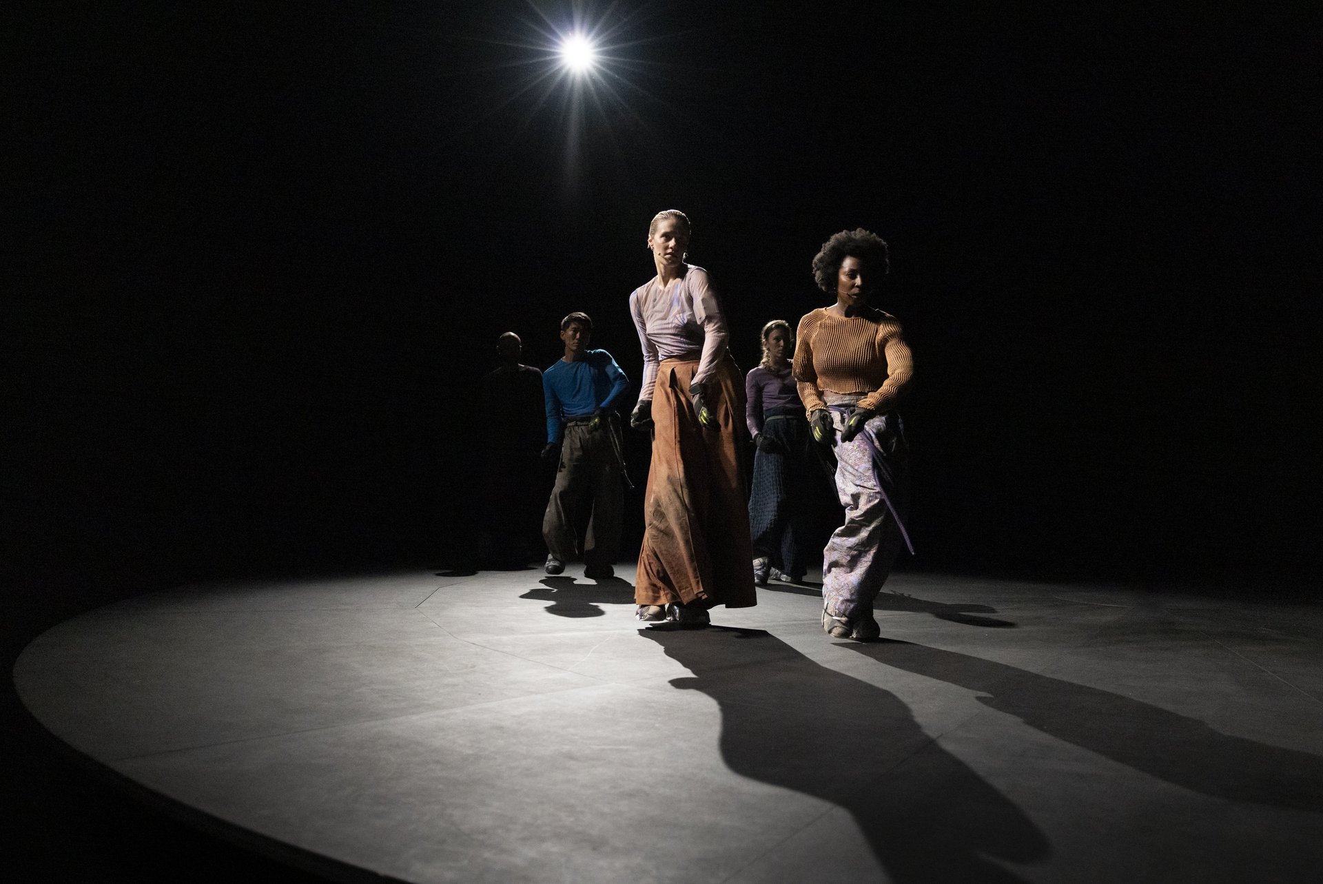 5 People in motion, dancing towards the camera.